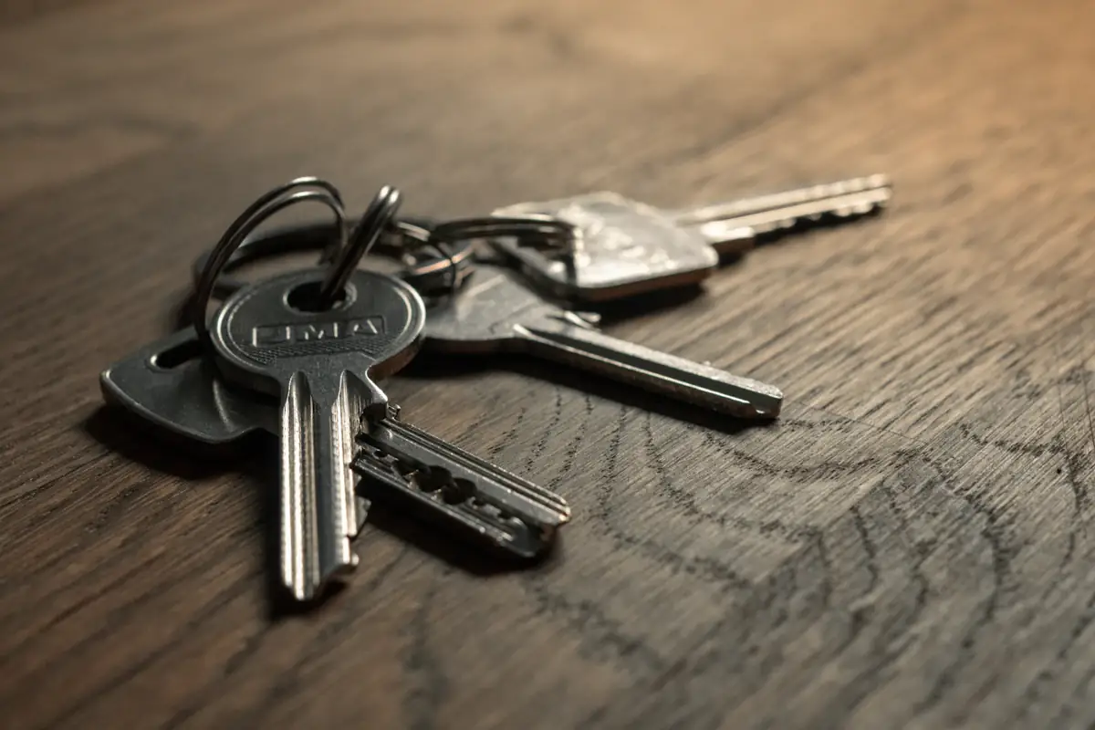 A set of house keys resting on a wooden table