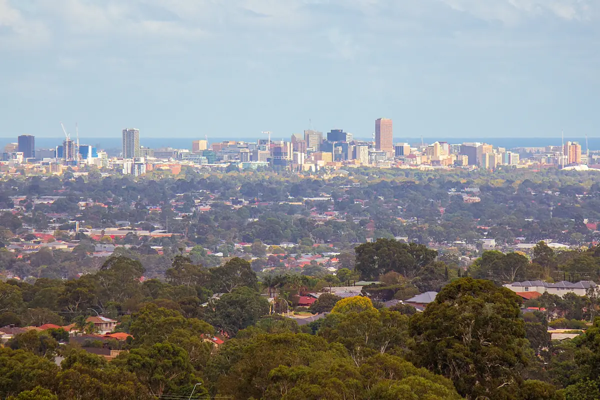 City skyline seen across suburbs and trees from the hills