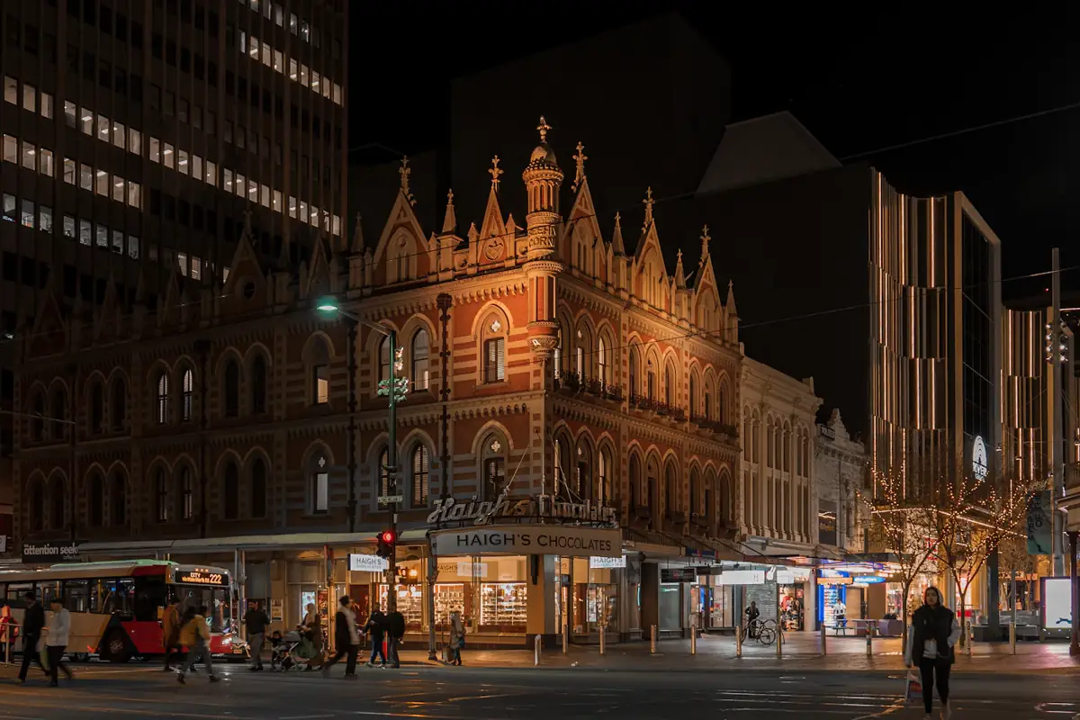 Heritage buildings on a city street lit up at night